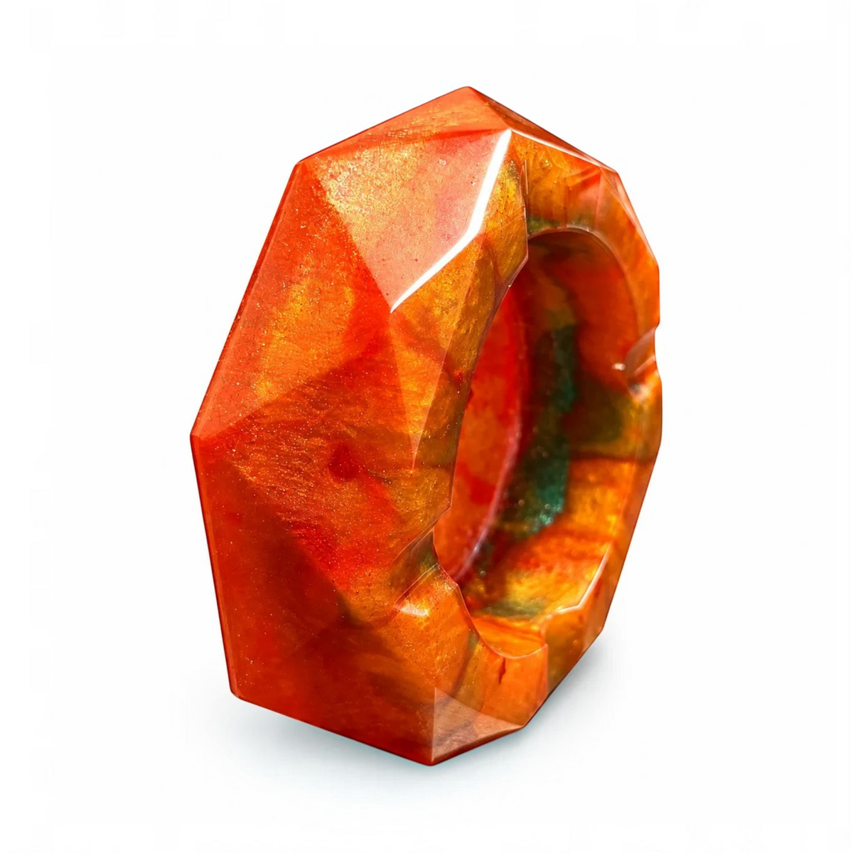 White Ashes Smoke Shop geometric resin ashtray in fiery orange, red, and gold with a glossy, multi-faceted finish.
