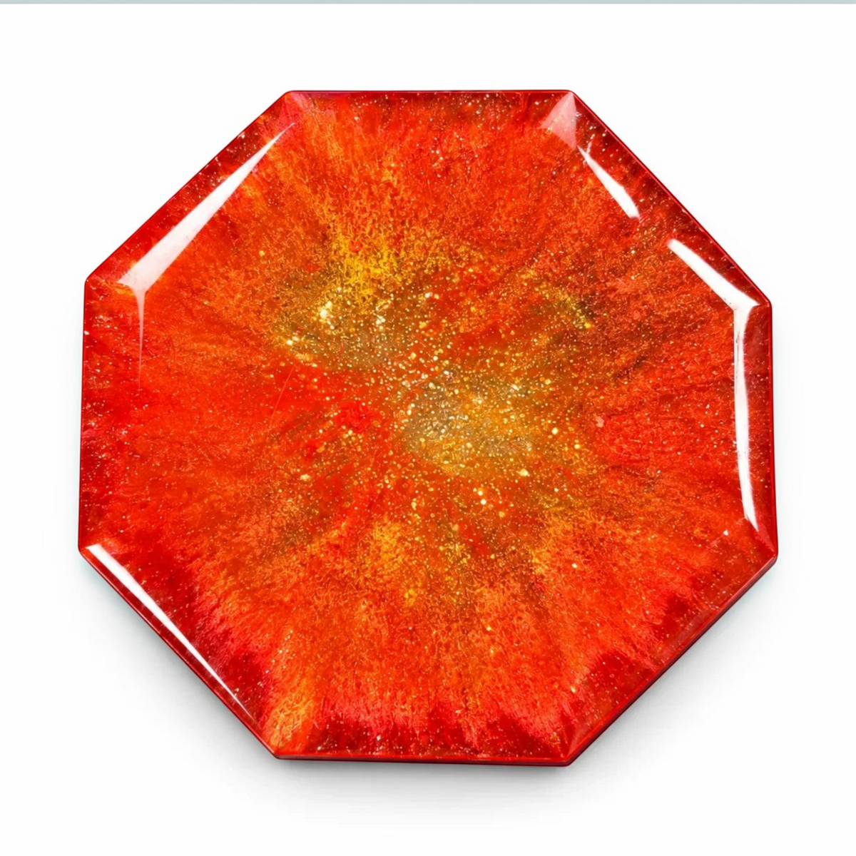 White Ashes Smoke Shop geometric resin ashtray in fiery red and orange with shimmering gold accents.