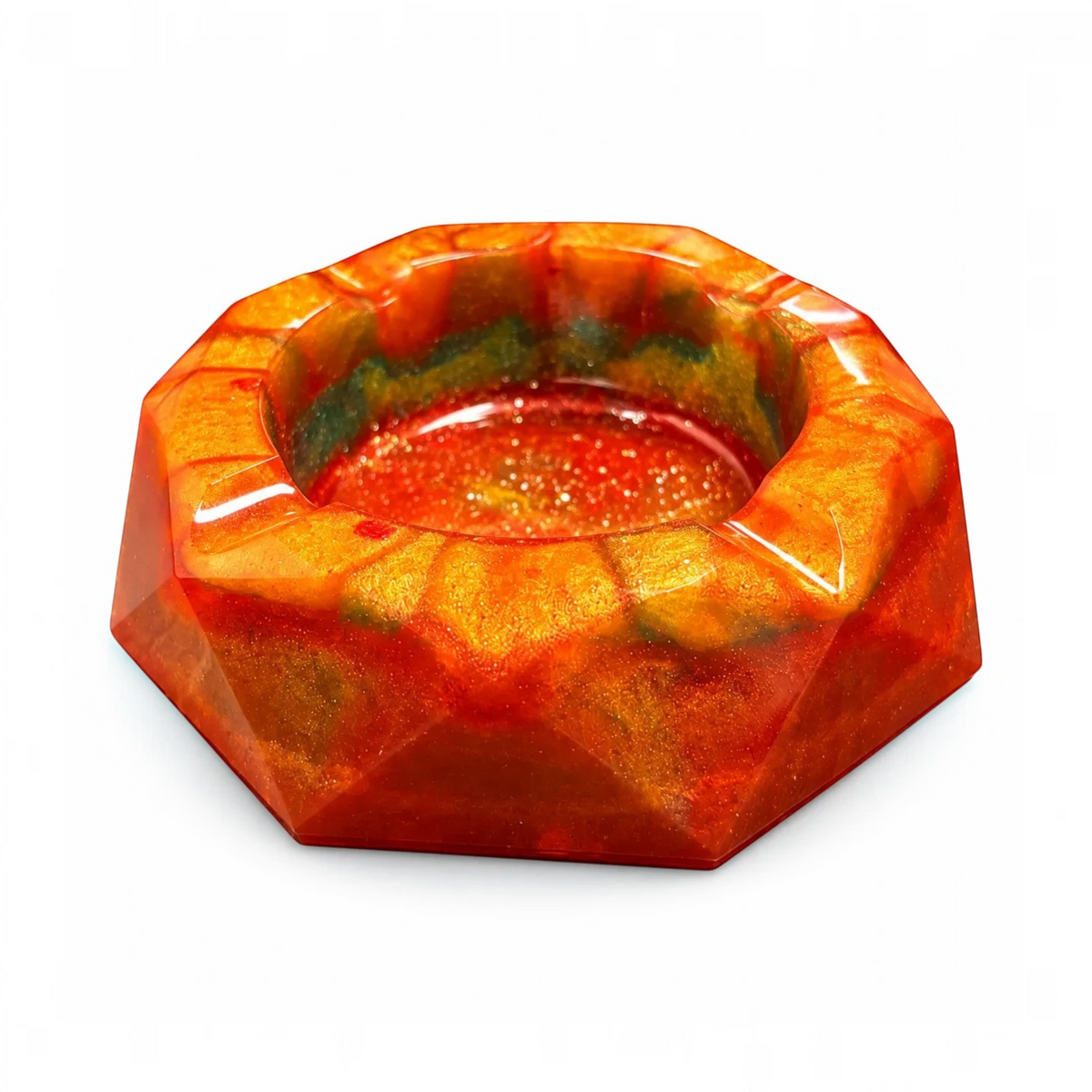 White Ashes Smoke Shop geometric resin ashtray in fiery orange, red, and gold with a glossy, multi-faceted finish.