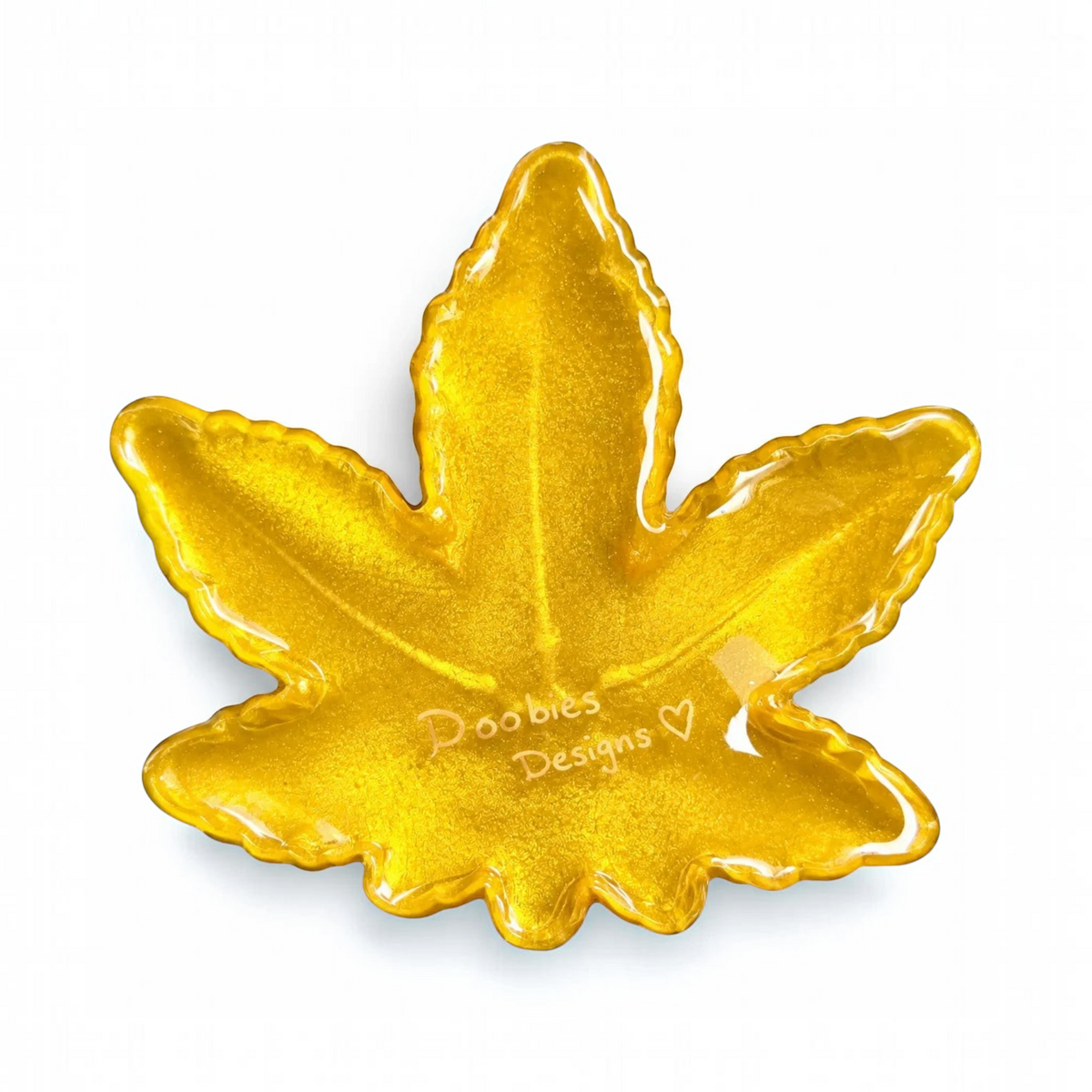 White Ashes Smoke Shop leaf-shaped resin ashtray in vibrant shimmering gold with a high-gloss finish.