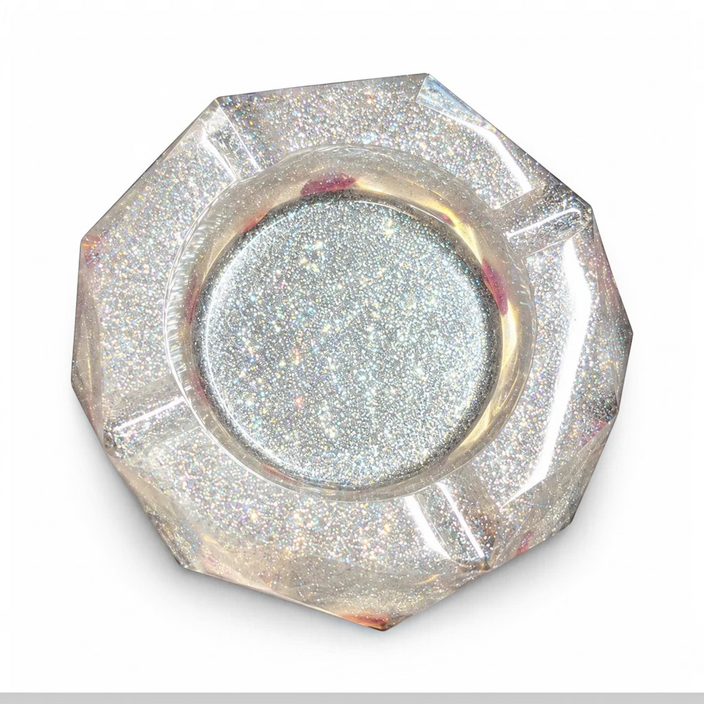 White Ashes Smoke Shop hexagonal resin ashtray with silver glitter and dried rose petals, top-down view.