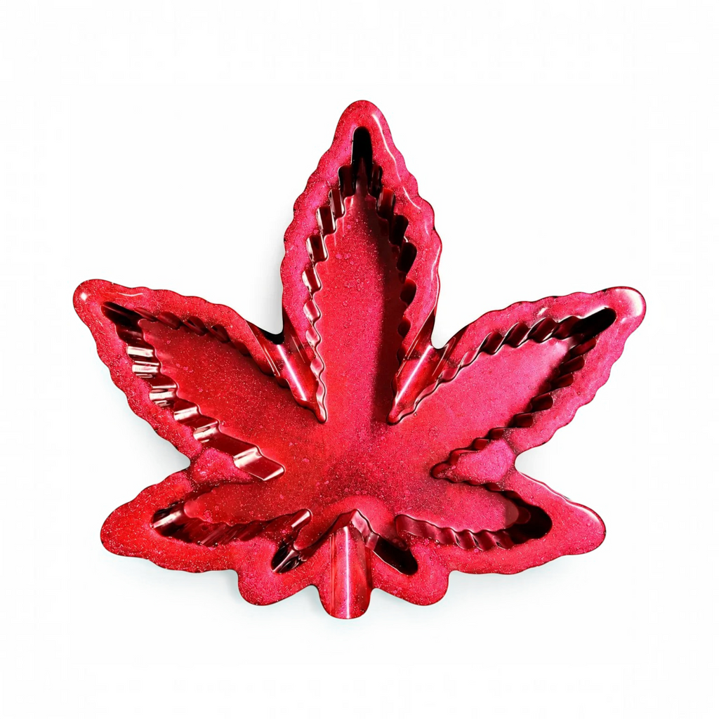 White Ashes Smoke Shop handcrafted red glitter resin leaf shaped smoking accessory tray with a high gloss finish.