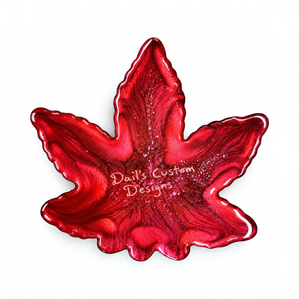 White Ashes Smoke Shop handcrafted red resin leaf-shaped tray with shimmering glitter and a high-gloss finish.